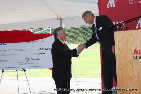 APSU President Tim Hall shakes hands with Hemlock Semiconductor LLC President and CEO Rick Doornbos after the University was presented with a 2 million dollar donation.