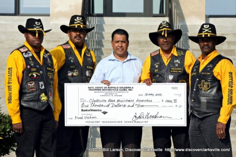 The Buffalo Soldier's Motorcycle Club presents a $1000.00 check to CAMA representative Pastor Tommy Vallejos to help flood victims. (Left to Right are: Business Manager Cedric "Cedix" Reid, Vice President Faisal "Face" Alim, Pastor Tommy Vallejos, Treasure Foster "Gee" Goodman, and Carl "Jazzman" Little).