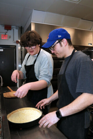 L – R, Danny McGlynn and Andrew Duenas making a Camacho’s Famous deep-dish pizza. (Tony Centonze, Clarksville Online)
