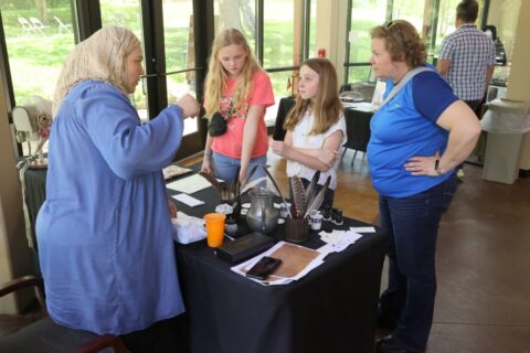 Roxanne Jenkins showing some kids the different quills used to write with in the 19th century. (Mark Haynes, Discover Clarksville)