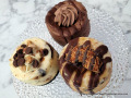 Three mini cheesecakes from B's Cheesecakes: Caramel Coconut Cookie with Samoa on top, Triple Chocolate in the back, and Tollhouse Chocolate with Peanut Caramel.